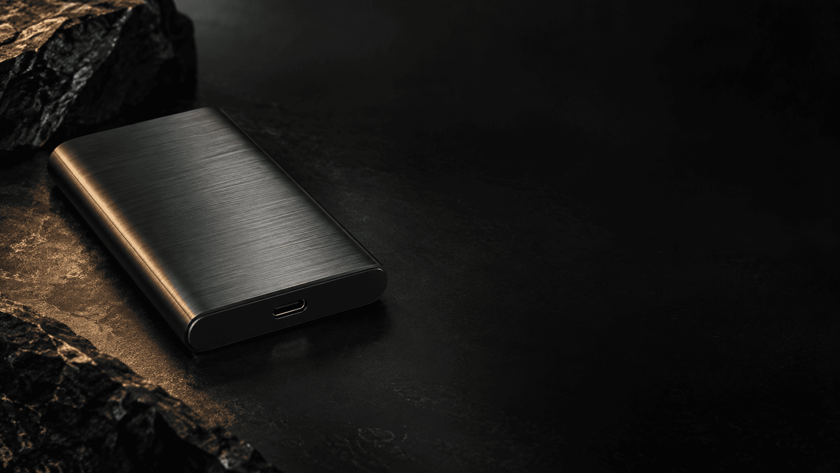 Graphite Self-Custody Drive against a bronze mineral light